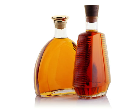 Two bottles of strong alcoholic beverages on a white backgroundの写真素材