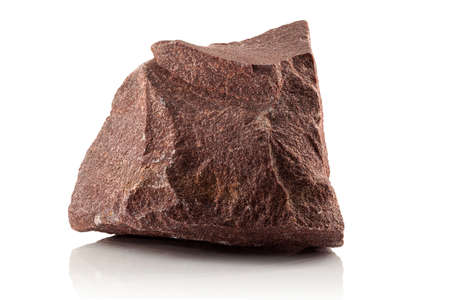 A stone, a rough fragment of crimson quartzite on a white backgroundの写真素材