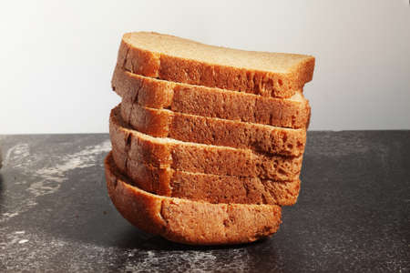 Sliced bread on a stone countertop.の写真素材