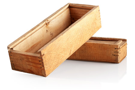 two old, roughly processed wooden boxes on a white backgroundの写真素材