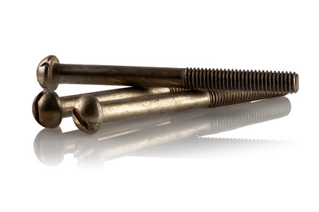 Three steel screws on a white reflective backgroundの写真素材