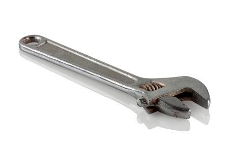 Steel wrench on a reflective white backgroundの写真素材