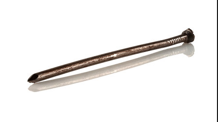 An old, rusty, bent nail on a white background.の写真素材