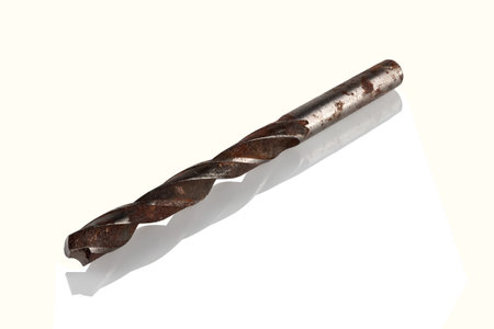 Old, rusty steel drill bit on a white backgroundの写真素材