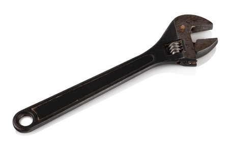 A black metal wrench on a white reflective background.の写真素材