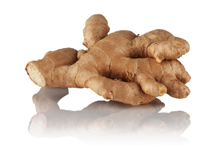 Ginger root on a white reflective background.の写真素材