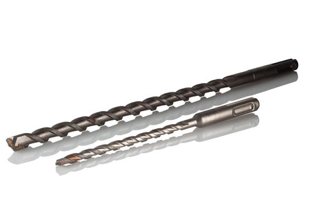 Two drills, of different diameters and different lengths, for drilling stone, concrete, brick on a white background.の写真素材