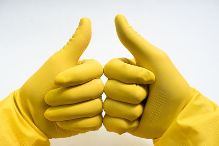 hands in yellow rubber glovesの写真素材