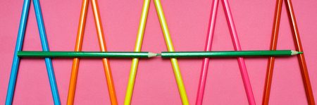 colored pencils on a pink backgroundの写真素材