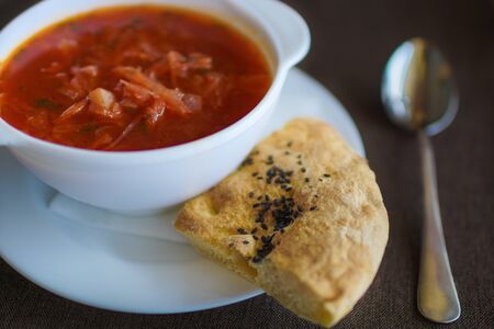 soup in a white plate with baked cake on gray backgroundの写真素材