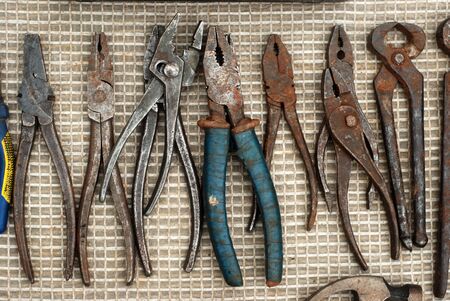 a set of old rusty pliers for work laid out on the floor