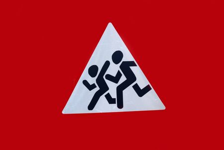 sign signifying cautiously children, the image of children running across the road