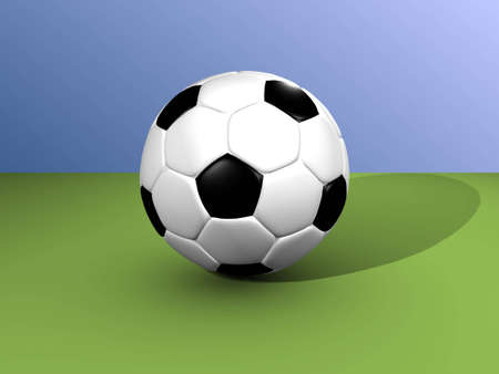 The football lays on a green football floorの写真素材