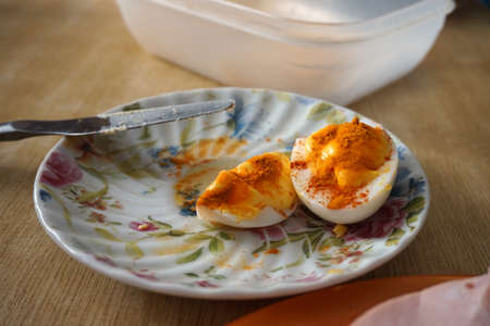 photo image of boiled sliced eggs with tartar sauce and spicesの写真素材