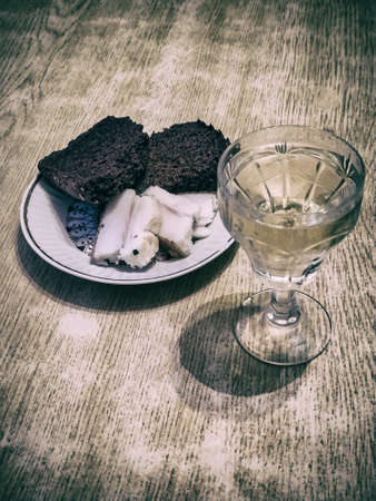 shot glass of vodka with rye bread and pork lard on the plateの写真素材