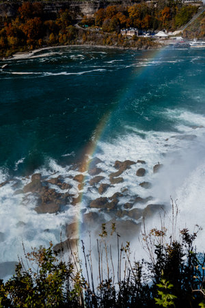 Niagara Falls from the American and Canadian sides. Rainbow over the waterfall. The most popular tourist place. Stormy river that flows into the lake.の写真素材