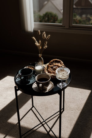 Aesthetic breakfast. Milk coffee, milk tea, sugar, almond, almond cakes, biscuits, marzipans and puffs. British breakfast in a cozy home. autumn mood.の写真素材
