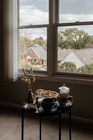 Aesthetic breakfast. Milk coffee, milk tea, sugar, almond, almond cakes, biscuits, marzipans and puffs. British breakfast in a cozy home. autumn mood.の写真素材