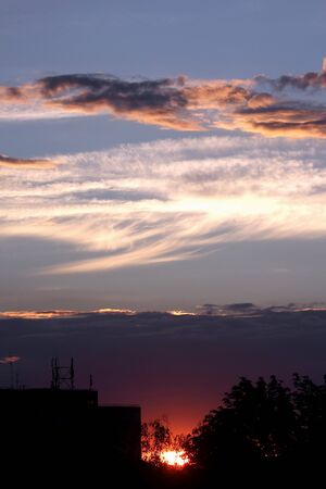 very bright sunset over the cityの写真素材