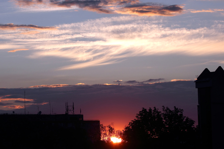 very bright sunset over the cityの写真素材