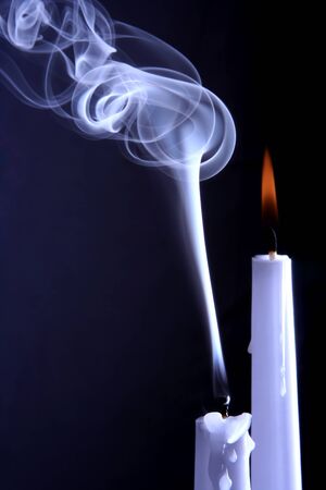 burning and extinguished the candles on dark backgroundの写真素材