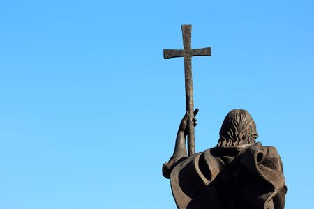 a monument of a man with a cross on sky backgroundの写真素材