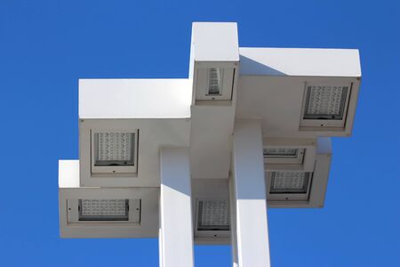 large white modern street lamp on blue sky backgroundの写真素材
