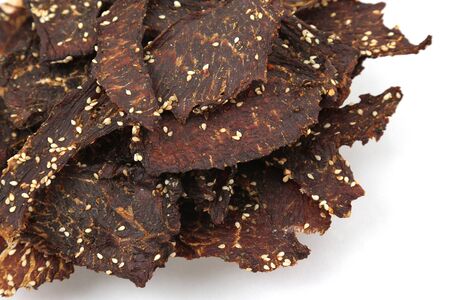 dried beef slices in spices with sesame seedsの写真素材