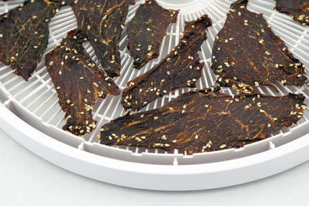 dried beef slices in spices with sesame seedsの写真素材