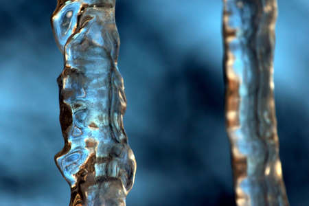 transparent icicle close up against the skyの写真素材
