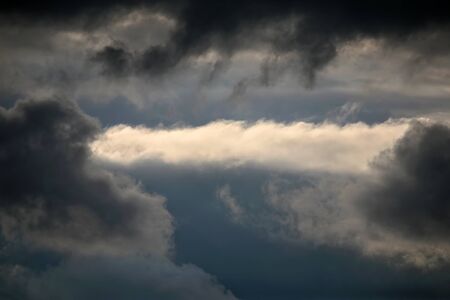 the expressive contrast of the clouds in the skyの写真素材