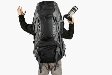 hiker with raised arms with a camera and a backpackの写真素材