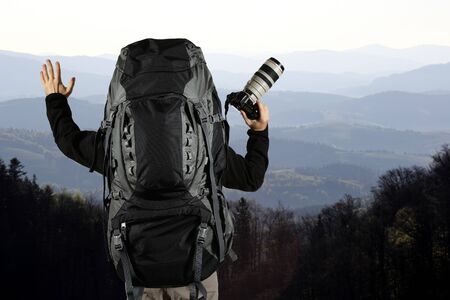 the a traveler with a backpack and your hands with a cameraの写真素材