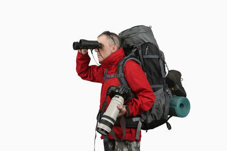 the equipped with the traveler photographer in a red jacket on a white background looking through binocularsの写真素材