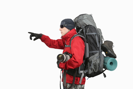 traveler in red jacket with backpack and camera in hand points into the distance hand on white backgroundの写真素材