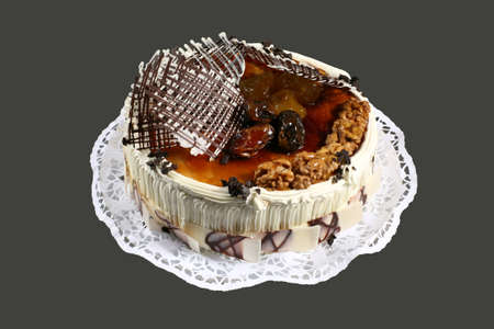 the sweet cake with nuts and dried fruits on gray backgroundの写真素材