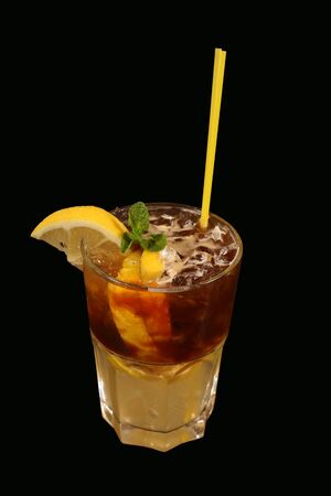 the cocktail with lemon on a black backgroundの写真素材