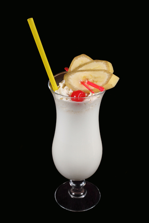 milkshake with banana and cherry on a black backgroundの写真素材