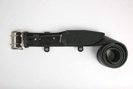 the knife in a leather sheath attached to a leather black strapの写真素材