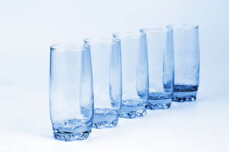 the five blue transparent glass with a light blue backgroundの写真素材