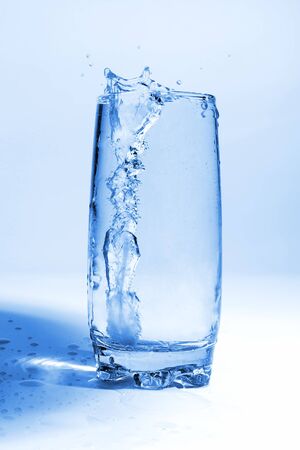 the water pouring in transparent glass with bubbles of airの写真素材