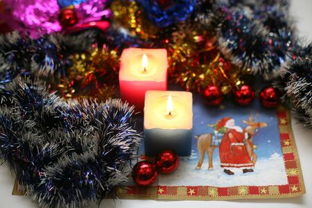 two burning candles with new year decorationの写真素材