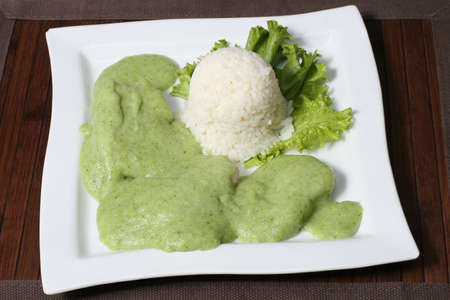 the serving of white rice with greens and green sauceの写真素材