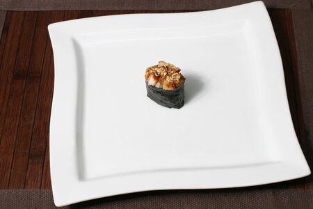 small portion sushi on a large square white plateの写真素材