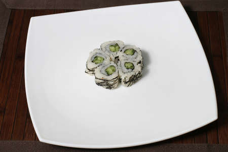the portion sushi on a large square white plateの写真素材