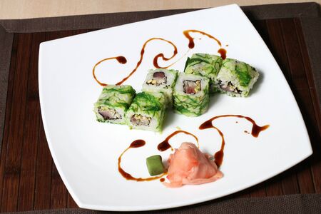 the portion sushi on a large square white plateの写真素材