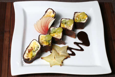 the nutritious fruit dessert in the form of sushiの写真素材