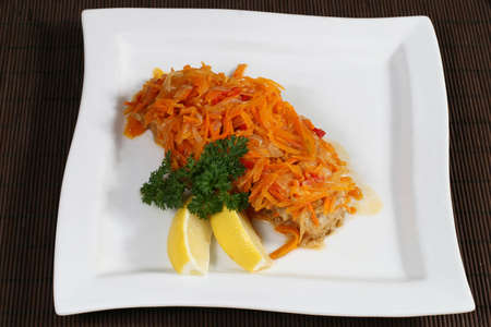 baked fish with carrots and lemonの写真素材