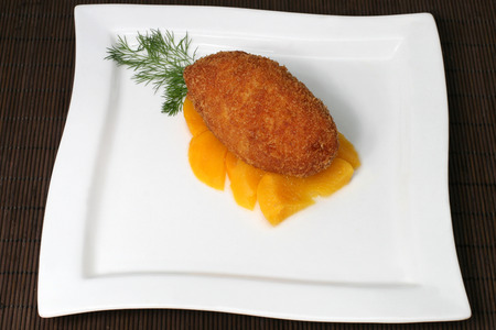 cutlet with peaches and greensの写真素材