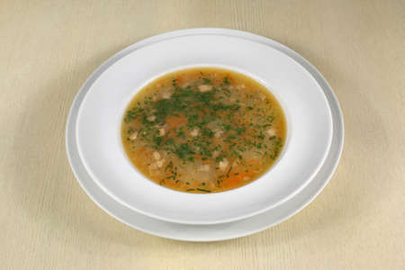 fish soup in white plate on the tableの写真素材